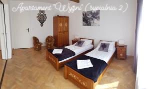 Posteľ alebo postele v izbe v ubytovaní Apartamenty MOŁS Zakopane