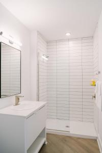 a white bathroom with a sink and a shower at Sonder The Lookout in Nashville