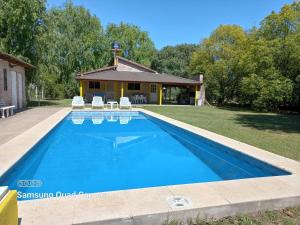 a swimming pool in front of a house at La Villarense in Buenos Aires