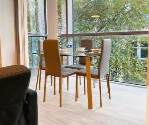 a dining room with a table and chairs in front of a window at stylish two bed in the heart of the city in Birmingham