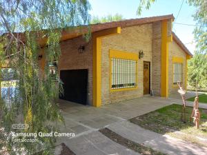 a house with a garage and a driveway at La Villarense in Buenos Aires