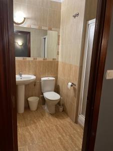 a bathroom with a toilet and a sink at Bakiola in Arrankudiaga