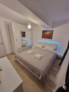 a bedroom with a large bed with two towels on it at DREAMS ESCAPE in Craiova