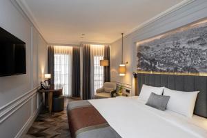 a hotel room with a large bed and a television at Livro Hotel in Istanbul