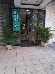 a store front with two potted plants in front of it at Atlantic Suites Hotel in Guayaquil