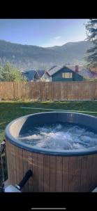 a large tub of water in a yard at Casa Belcin Spa&Retreat in Buşteni