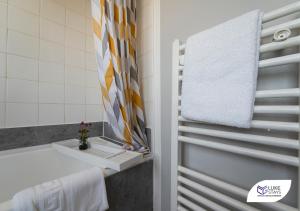 a white bathroom with a sink and a towel at Luke Stays - Ashdown in Durham