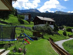 a backyard with a playground and a swing at Haus Anita in Fendels