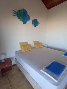 a bed with two pillows on it in a room at Casa do Capitao in Guajiru
