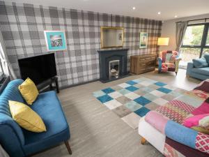 a living room with a couch and a fireplace at Vista Tasso in Holmfirth