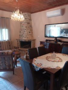 a dining room with a table and a fireplace at Sminos Farm House E4 path, Γυθειο 