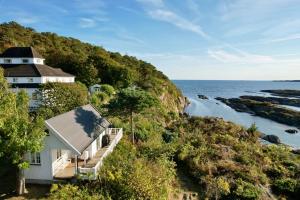 a house on a hill next to the ocean at Langesund Bad in Langesund