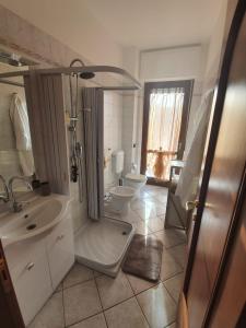 a bathroom with a shower and a sink and a toilet at Casa Bellavista in Neive