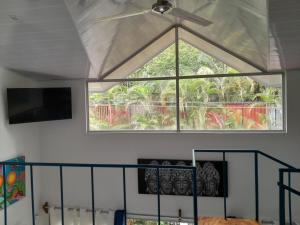 a window in a room with a ceiling fan at Casas Guaney in Manuel Antonio