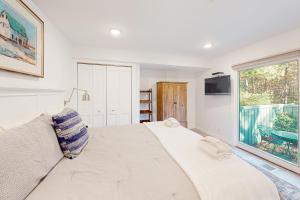 a bedroom with a large bed and a window at Sandpiper 1 in Glen Arbor
