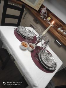 a table with two plates and bowls of food on it at Belle suite parentale in Laize-la-Ville