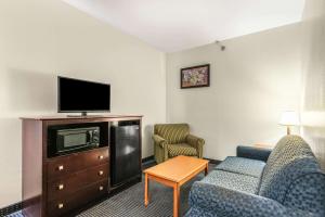 Habitación de hotel con sofá y TV en Econo Lodge Inn & Suites Pritchard Road North Little Rock, en North Little Rock