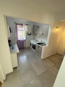 a small kitchen with white cabinets and a stove at Apartament Anca in Gura Humorului