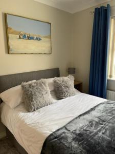uma cama com almofadas num quarto em Ballycastle Best Times em Ballycastle