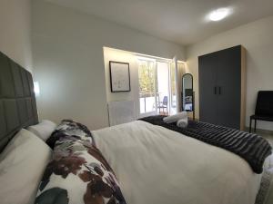a bedroom with a large bed and a window at Apartaments Font del Cirerer in Sant Hilari Sacalm +86 photos