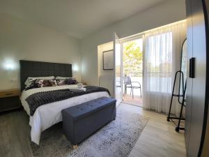 a bedroom with a bed and a sliding glass door at Apartaments Font del Cirerer in Sant Hilari Sacalm