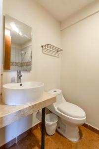 a bathroom with a white sink and a toilet at Hotel Meson de Sara in Quer&eacute;taro