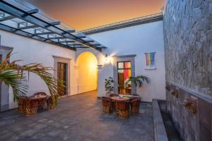 a courtyard with tables and chairs in a building at Hotel Meson de Sara in Querétaro