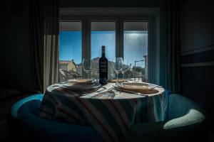 a table with a bottle of wine and glasses at Gold Coast Photography Inn in Estoril