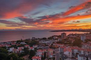 a view of a city at sunset at Gold Coast Photography Inn in Estoril
