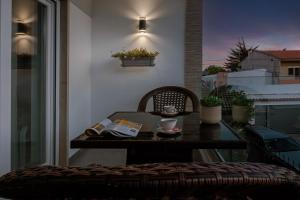 a table and chair on a balcony with a cup of coffee at Gold Coast Photography Inn in Estoril