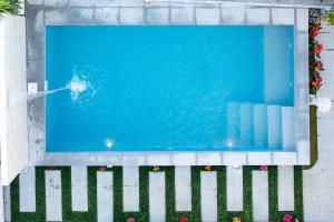 a swimming pool next to a white fence at Gold Coast Photography Inn in Estoril