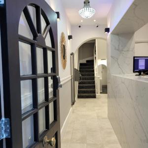 a door leading to a hallway with a staircase at Argyle Square Hotel in London
