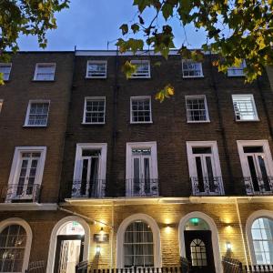 a large brick building with white windows and lights at Argyle Square Hotel in London