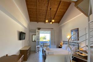 a bedroom with a bed and a desk in a room at Pantazis Studios in Agios Nikitas in Agios Nikitas