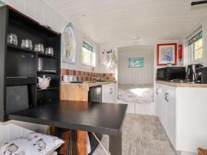a kitchen with a black counter top in a room at The View in Callington