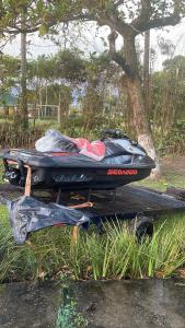 a boat sitting on a trailer next to a tree at Pousada Lifestyle Ilhabela in Ilhabela