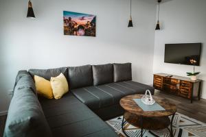 a living room with a couch and a table at Hercegovina apartments in Mostar
