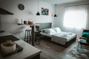 a bedroom with a bed and a table in a room at Hercegovina apartments in Mostar