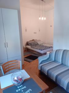 a living room with a couch and a bed at Donata in Osijek