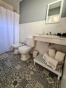 a bathroom with a toilet and a sink at Las Lilas Cabañas in La Rioja