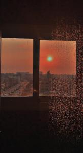 a view of a sunset from a window in a room at بيت السمو in Cairo