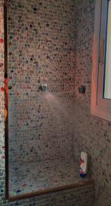 a bathroom with a shower with a mosaic tile wall at بيت السمو in Cairo