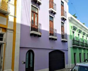 un edificio púrpura con balcones en una calle en KASA The Lofts 302, en San Juan
