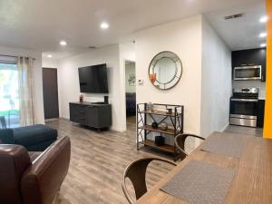 a living room with a couch and a table at Perfect Palm Springs Pied-à-terre in Palm Springs