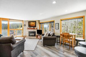 a living room with a couch and a table and chairs at Watch Hill 216 in Silverthorne