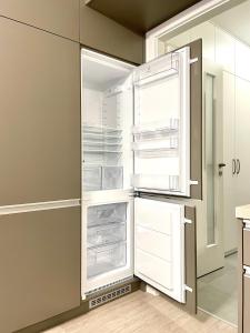 an empty refrigerator with its door open in a kitchen at Top in Bratislava