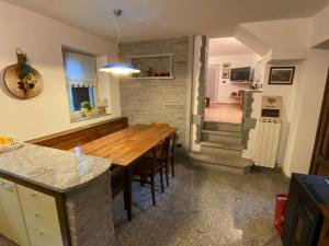 een keuken en eetkamer met een houten tafel bij Casa Schiappo Montagna Natura e Relax. 
