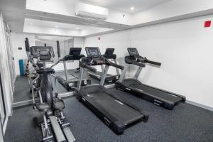 a gym with several cardio machines in a room at Top Floor on Okanagan Lake with AC & Heated Pool in Vernon