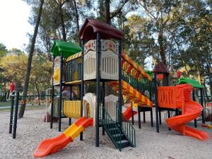 a playground with colorful play equipment in a park at Green Park - Studio in Punta del Este