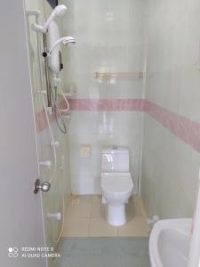 a small bathroom with a toilet and a shower at Coco Cottage Local Style in Guraidhoo